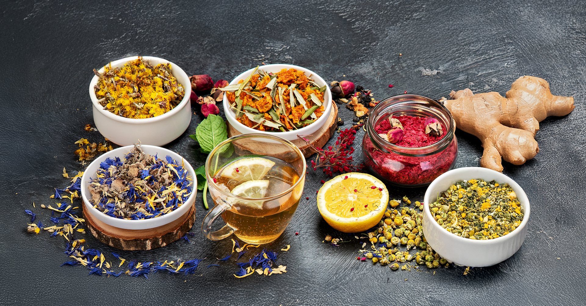 a variety of herbal teas shown with a cup of hot herbal tea with lemon